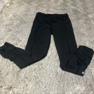 LuLuLemon black leggings with reflective stripe and zipper at the ankles